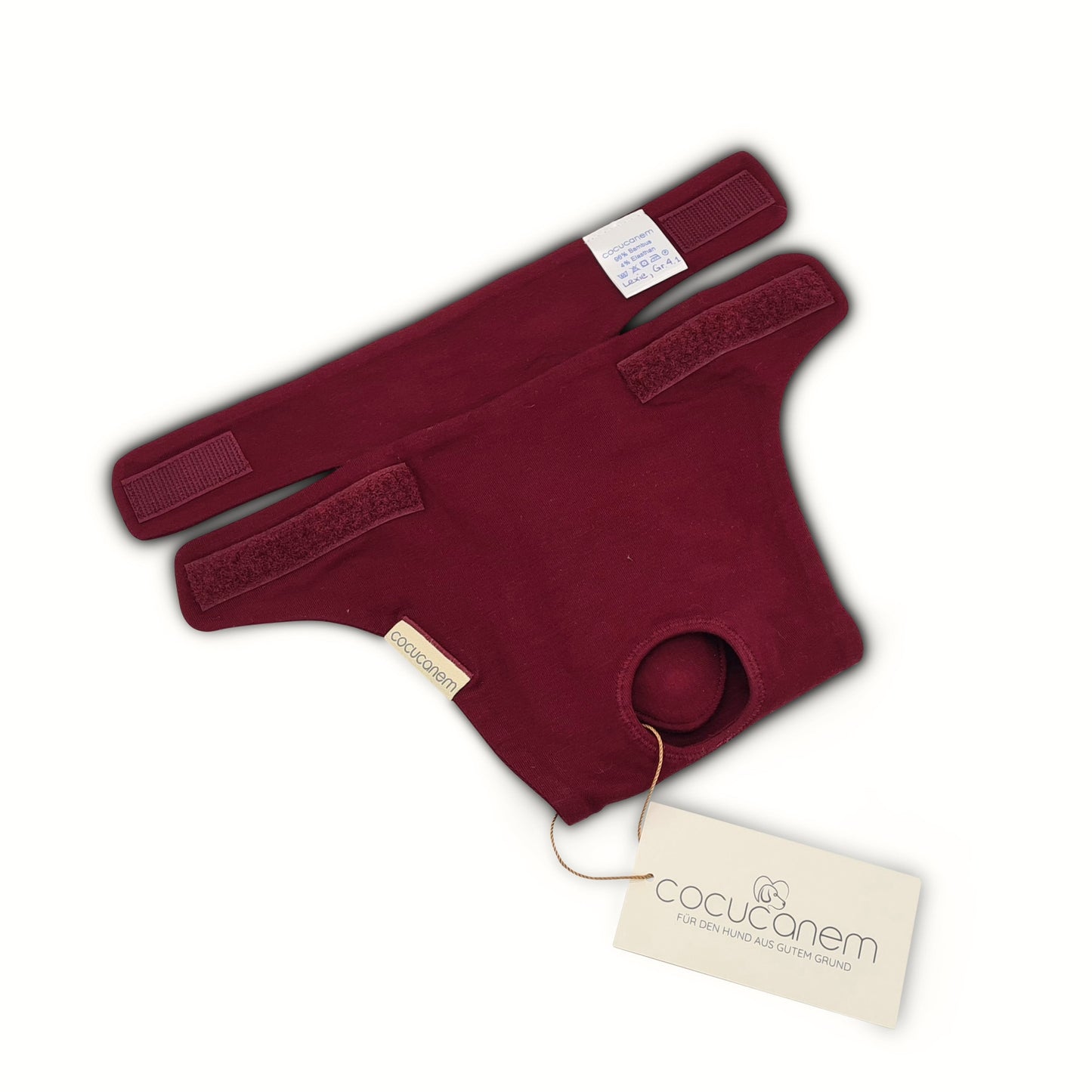 Detailansicht der Klettverschlüsse der Läufigkeitshose Lexie. Die Läufigkeitshose ist in der Hälfte aufeinandergefaltet, so dass man einen sehr guten Blick auf die Flügel mit den Klettverschlüssen hat, die die Hose stufenlos an der Taille fixieren.